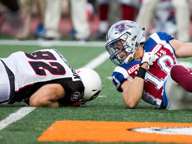 Montreal Alouettes safety Marc-Olivier Brouillette looks back at Ottawa Redblacks wide receiver Greg Ellingson after the two collided in mid-air during CFL action at the Percival Molson Stadium in Montreal on Thursday June 25, 2015.