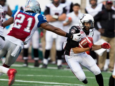 Montreal Alouettes safety Mike Edem gets a hand on Ottawa Redblacks wide receiver Chris Williams during CFL action at the Percival Molson Stadium in Montreal on Thursday June 25, 2015.