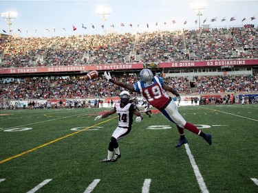 Montreal Alouettes slotback S.J. Green reaches for a long pass as Ottawa Redblacks defensive back Abdul Kanneh looks on during CFL action at the Percival Molson Stadium in Montreal on Thursday June 25, 2015.