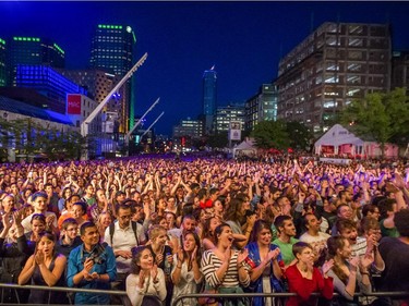 Music fans cheer as they fill Place des Art before the performance by the American music group Beirut for the Montreal International Jazz Festival at Place des Arts in Montreal on Friday, June 26, 2015.