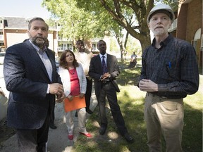 NDP leader Thomas Mulcair, left, speaks with architect Douglas Alford, right, as he tours the Cloverdale housing cooperative in Pierrefonds on Friday, June 26, 2015.