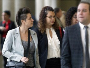 Nicholas Thorne-Belance's mother, Stephanie Thorne, centre, arrives at the Longueuil courthouse in 2015, for the appearance of officer Patrick Ouellet.