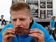 Tyler Kirk digs in to some ribs from Blazin' BBQ Ribhouse during the Rib Fest in Montreal on Monday, June 29, 2015.