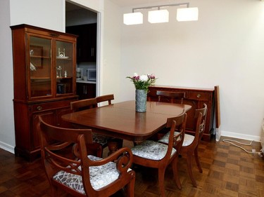 A wooden dining room set is featured in Emily Shore's apartment.   The table and chairs are from her childhood home and were given to her by her parents.