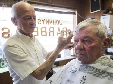 Barber John Chvila cuts Dave Andres's hair in Baroda, Mich.