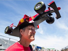Formula One fan Kim Reimer from Tallahassee, Fla., shows off his hand-made hat with the design of Ferrari driver Sebastian Vettel during open house day for the Canadian Grand Prix at Circuit Gilles Villeneuve in Montreal on  June 4, 2015. Reimer has made 12 detailed hats with accurate designs and has garnered a lot of attention online.