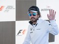 McLaren driver Fernando Alonso waves to fans during an autograph signing session during open house for the Canadian Grand Prix at Circuit Gilles Villeneuve in Montreal on June 4, 2015.