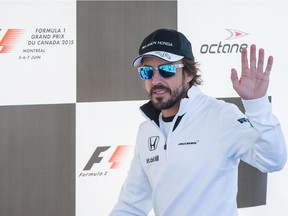 McLaren driver Fernando Alonso waves to fans during an autograph signing session during open house for the Canadian Grand Prix at Circuit Gilles Villeneuve in Montreal on June 4, 2015.