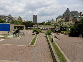 A man walks past Charles Daudelin's sculpture, Mastodo, in Viger Square in Montreal on Friday June 5, 2015. Mastodo, a fountain that tips once filled with water, is inside the Agora, a massive concrete public art work located in Viger Square. The city is planning a major facelift of the square which will see the concrete structure demolished but preserve Mastodo if the Daudelin family agrees.