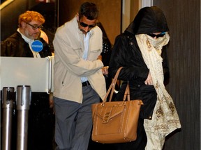 Essam Jamali, the father of  El Mahdi Jamali, 18, leaves the Montreal courthouse June 5, 2015, with a woman who is believed to be either another Jamali relative or family member of El Mahdi's co-accused, Sabrine Djermane, 19.