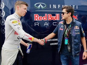 Red Bull Formula One driver Daniil Kvyat of Russia, left, meets with 15-year-old Canadian karting champion Gianfranco Mazzaferro in the paddocks before the second practice session for the Canadian Grand Prix at Circuit Gilles Villeneuve in Montreal on June 5, 2015.