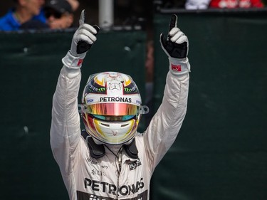 Mercedes Formula 1 driver Lewis Hamilton of Great Britain celebrates as he gets out of his car after finishing first in the F1 Canadian Grand Prix at Circuit Gilles-Villeneuve in Montreal on Sunday, June 7, 2015.