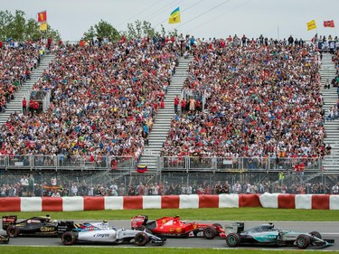 Mercedes Formula 1 driver Lewis Hamilton of Great Britain, right, exits turn three followed by other drivers at the start of the Canadian Grand Prix at Circuit Gilles-Villeneuve in Montreal on Sunday, June 7, 2015.