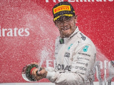 Mercedes Formula 1 driver Lewis Hamilton of Great Britain sprays champagne as he celebrates his first place finish at the Canadian Grand Prix at Circuit Gilles-Villeneuve in Montreal on Sunday, June 7, 2015. Mercedes driver Nico Rosberg of Germany came second followed by Williams driver Valtteri Bottas of Finland in third place.