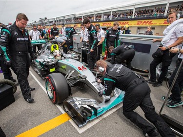 Mercedes Formula 1 driver Lewis Hamilton of Great Britain places his car on pole position at the starting grid before the start of the F1 Canadian Grand Prix at Circuit Gilles-Villeneuve in Montreal on Sunday, June 7, 2015.