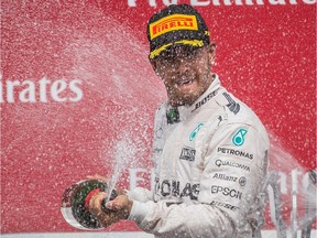 Mercedes driver Lewis Hamilton of Great Britain sprays champagne as he celebrates his victory at the Canadian Grand Prix at Circuit Gilles Villeneuve in Montreal on June 7, 2015.
