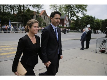 Federal Liberal leader Justin Trudeau arrives with his wife Sophie Grégoire arrive at the Saint-Germain d'Outremont Church for the funeral of former Quebec Premier Jacques Parizeau, Tuesday June 9, 2015.