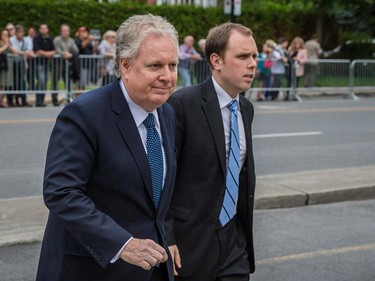 Former Quebec Premier Jean Charest, left, arrives for the funeral for former Quebec premier Jacques Parizeau at Saint-Germain d'Outremont Church in Montreal on Tuesday, June 9, 2015.