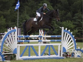 A horse makes a jump at the Desjardins Grand Prix competition, one of the spotlight events at this year's Concours Pepiniere St-Lazare, on Saturday, May 30, 2015.