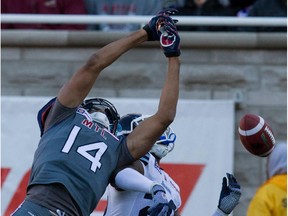 MONTREAL, QUE.: NOVEMBER 2, 2014-- Montreal Alouettes wide receiver Brandon London, left, misses a long pass after colliding with Toronto Argonauts defensive back Orhian Johnson during CFL action at the Molson Stadium in Montreal on Sunday November 2, 2014.  (Allen McInnis / MONTREAL GAZETTE)
