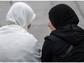 Women chat in Emilie-Gamelin Park before a demonstration opposing the proposed Charter of Quebec Values in 2013.