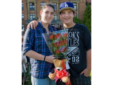 Shannon O'Shea Boulanger, and her brother Jessie, hold a surprise gift of roses and a teddy bear, purchased for their sister Meaghan, a Social Sciences graduate, during convocation ceremonies held outdoors in front of the Hertzberg Building at John Abbott College in Ste. Anne-de-Bellevue, Quebec on June 11, 2015. Established in 1971, some  2,000 students graduated, with 425 diplomas and honours certificates being awarded.