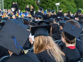 Students watch evening convocation ceremonies held outdoors in front of the Hertzberg Building at John Abbott College in Ste-Anne-de-Bellevue June 11, 2015.