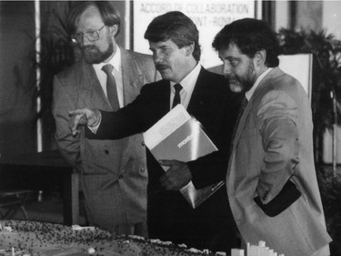 Montreal mayor Jean Doré looks at a scale model of Mount Royal prior to a press conference. To Doré's righ is Hubert Simard and John Gardiner, member of the MUC council on housing and urban planning is at his left.