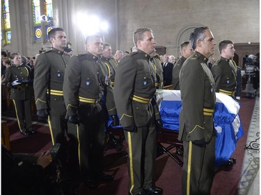 Pallbearers carry the casket of Jacques Parizeau into the church at the state funeral for the former Quebec premier in Montreal on Tuesday, June 9, 2015.