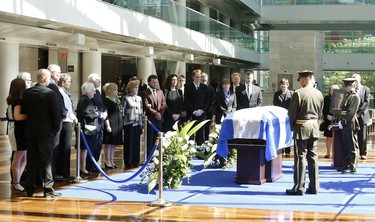 The family of former Quebec premier Jacques Parizeau visits his casket lying in state at theCaisse de dépôt et placement du Québec in Montreal on Saturday, June 6, 2015. THE CANADIAN PRESS/ Patrick Doyle
