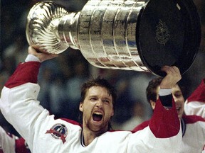 Goalie Patrick Roy holds the Stanley Cup aloft at the Montreal Forum after the Canadiens won the Stanley Cup on June 9, 1993, beating the Los Angeles Kings in five games.