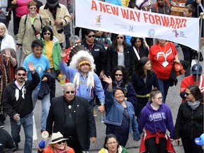Assembly of First Nations Chief Perry Bellegarde (in headdress) and Justice Murray Sinclair (in black suit), TRC commissioner, march during the Walk for Reconciliation, part of the closing events of the Truth and Reconciliation Commission on Sunday, May 31, 2015 in Gatineau, Que.