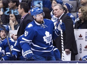 Toronto Maple Leafs forward Phil Kessel moves down the bench in front of interim head coach Peter Horachek during game against the Columbus Blue Jackets in Toronto on Jan. 9, 2015.