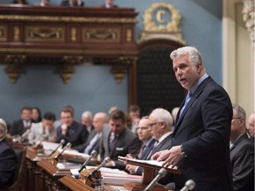 Quebec Premier Philippe Couillard speaks to members of the National Assembly as he unveils details of the government's plans to combat de-radicalization and ensure the religious neutrality of the state on  Wednesday, June 10, 2015.