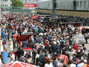 Race fans crowd pit lane during the open house day at Circuit Gilles Villeneuve on Thursday. More than 300,000 F1 enthusiasts attend the Grand Prix race.