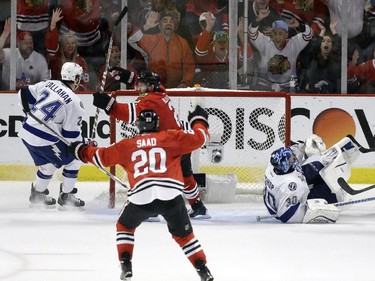 Chicago Blackhawks' Duncan Keith celebrates with teammate Brandon Saad (20) after scoring past Tampa Bay Lightning goalie Ben Bishop (30) and Ryan Callahan (24) during the second period in Game 6 of the NHL hockey Stanley Cup Final Monday, June 15, 2015, in Chicago.
