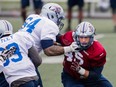 Brian Brikowski, right, takes part in the Alouettes' training camp at Bishop's University in Lennoxville on Sunday, May 31, 2015.