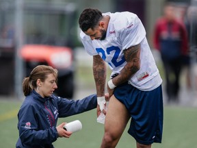 Cody Hoffman takes a break to work on his leg during Alouettes training camp at Bishop's University in Lennoxville on May 31, 2015.