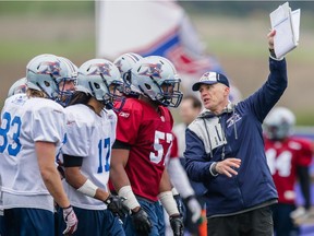 Alouettes head coach Tom Higgins runs through plays during  training camp at Bishop's University in Lennoxville on May 31, 2015.