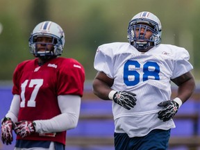 Philip Blake, right, takes part in the Montreal Alouettes training camp at Bishop's University in Lennoxville on Sunday, May 31, 2015.