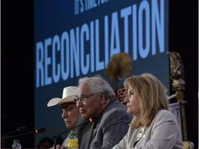 Commission chairman Justice Murray Sinclair (centre) and fellow commissioners Marie Wilson (right) and Wilton Littlechild discuss the commission's report on Canada's residential school system at the Truth and Reconciliation Commission in Ottawa on Tuesday, June 2, 2015.