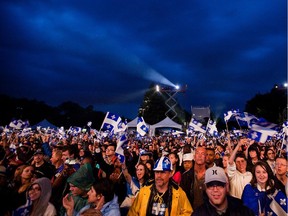 Fans wave their Quebec flags during the Fete Nationale on St-Jean Baptiste at Maisonneuve park in Montreal on Friday, June 24, 2011.