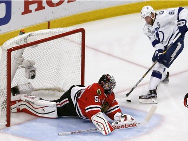 Chicago Blackhawks goalie Corey Crawford, left, makes a save on a shot by Tampa Bay Lightning's Steven Stamkos during the second period in Game 6 of the NHL hockey Stanley Cup Final series on Monday, June 15, 2015, in Chicago.