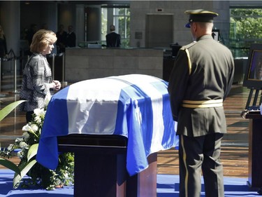 Lisette Lapointe, wife of former Quebec premier Jacques Parizeau, visits her husband's casket lying in state at the Caisse de dépôt et placement du Québec in Montreal on Saturday, June 6, 2015.