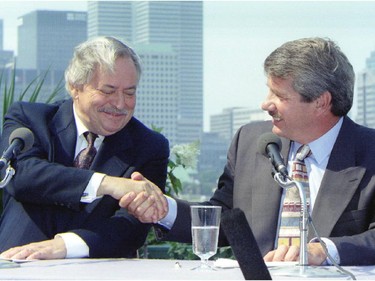 With the Montreal city skyline in the background, PQ leader Jacques Parizeau and Montreal mayor Jean Doré shake hands outside of city hall on Wednesday, August 17, 1994. The two were holding a joint news conference.