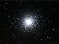 The Great Hercules Cluster is a mass of hundreds of thousands of stars that sits 24,000 light years from Earth and is visible through binoculars and backyard telescopes in June.