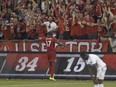 Toronto FC's Jozy Altidore celebrate with fans after scoring goal against the Montreal Impact during MLS game in Toronto on June 24, 2015. Toronto won the game 3-1.