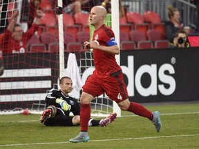 Toronto FC's Michael Bradley (4) celebrates his goal as Montreal Impact keeper Evan Bush reacts during first half MLS action in Toronto on Thursday June 24, 2015.