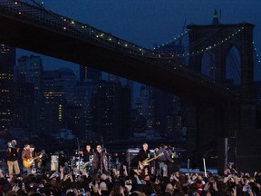 NEW YORK - NOVEMBER 22:  The rock group U2 performs during the taping of a music video at Empire-Fulton Ferry State Park November 22, 2004 in the Brooklyn borough of New York City.