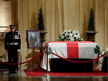A Montreal police honor guard stands in the Hall of Honour as former Montreal mayor Jean Doré lies in state at Montreal city hall on Sunday June 21, 2015.
